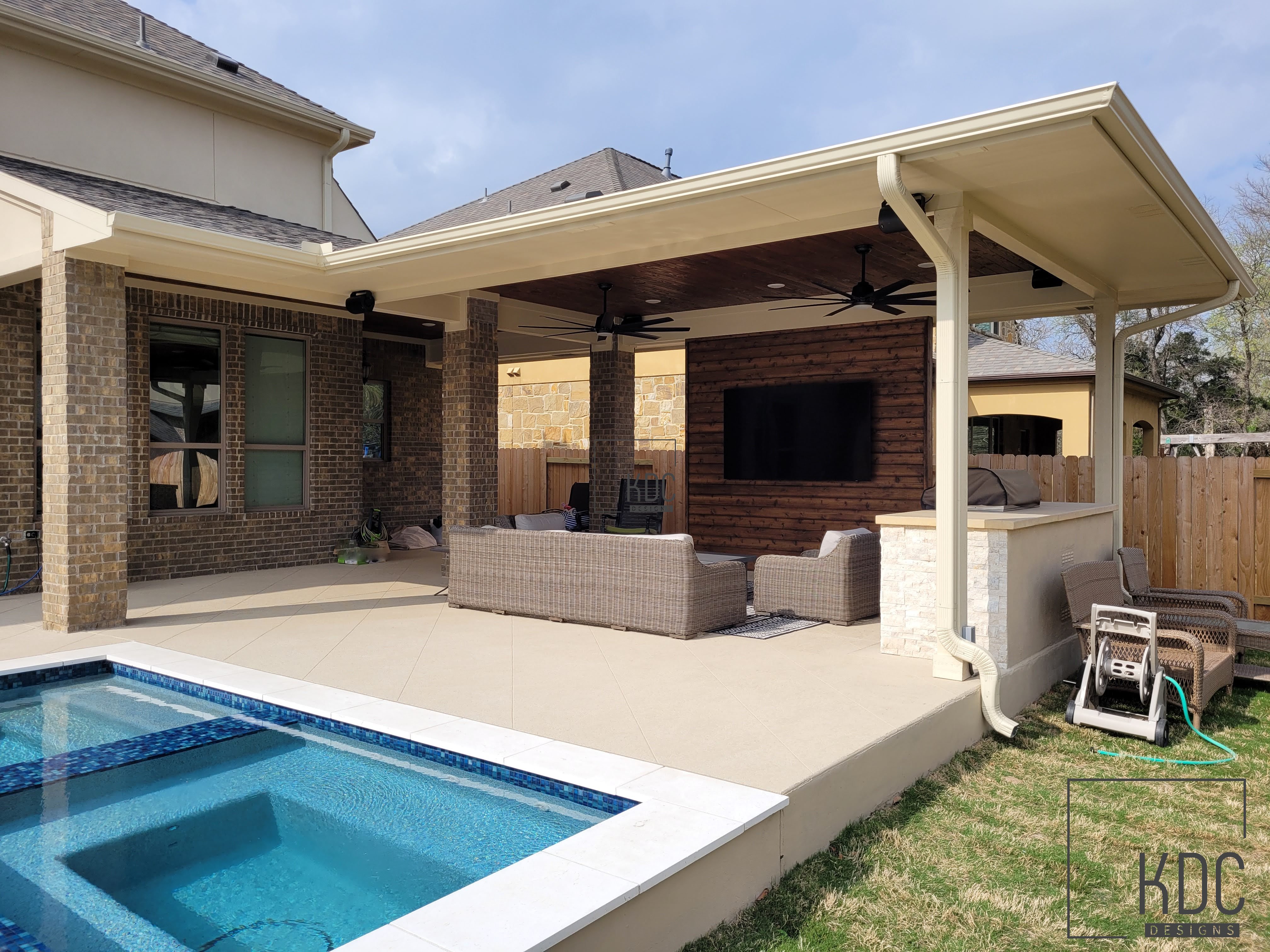 Covered patio with cedar ceiling and stone columns built by KDC Designs in Central Texas