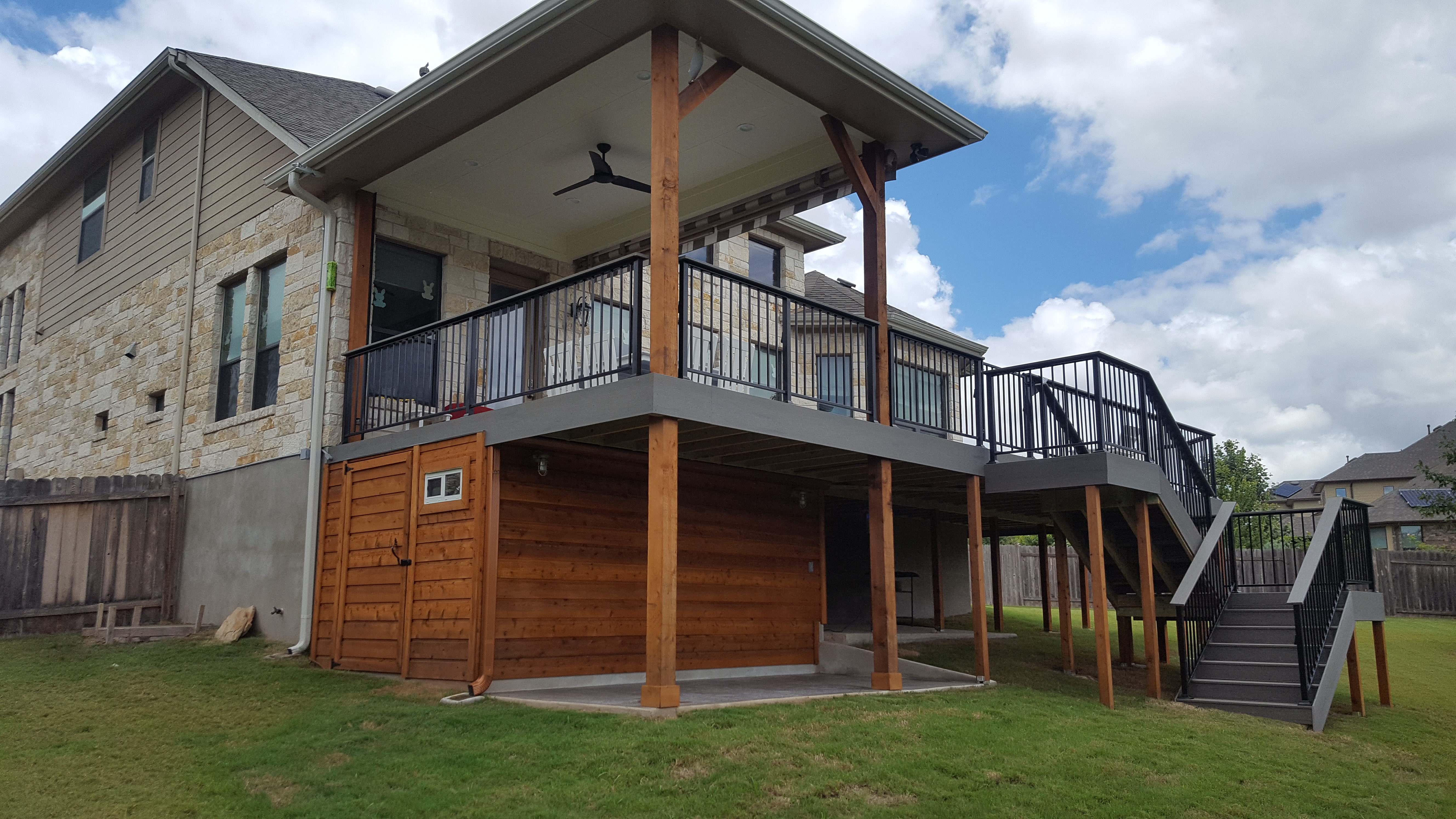 Elevated custom deck with covered patio and under-stair storage built by KDC Designs in Central Texas