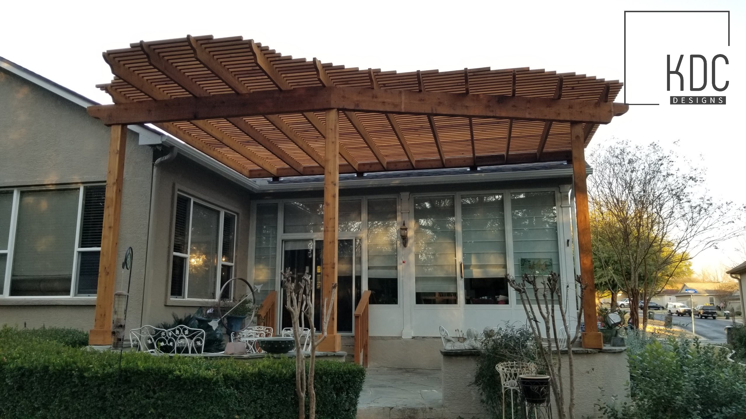 Custom patio with cedar pergola cover by KDC Designs Austin TX