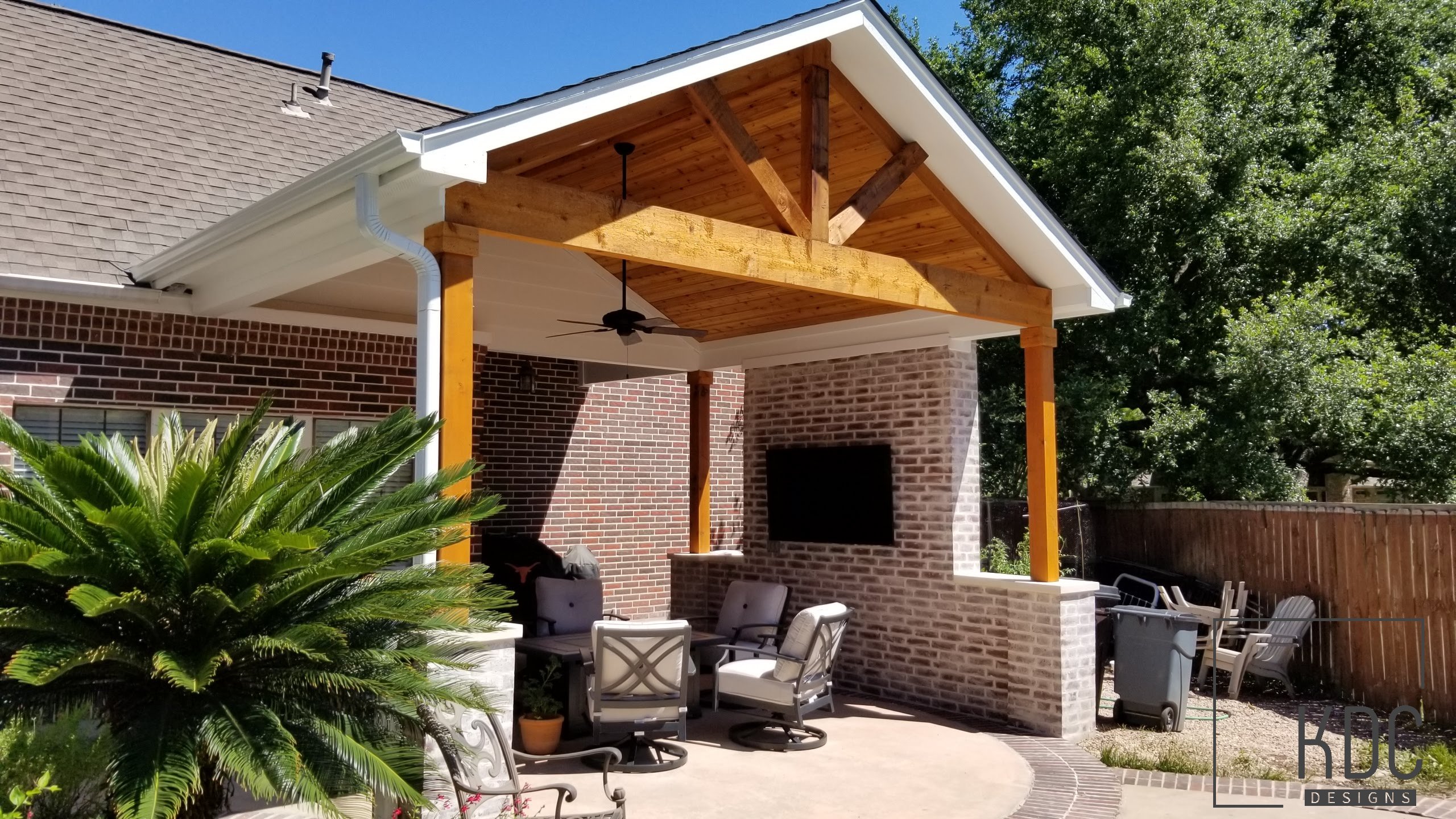 Custom roof extension creating covered outdoor living space by KDC Designs